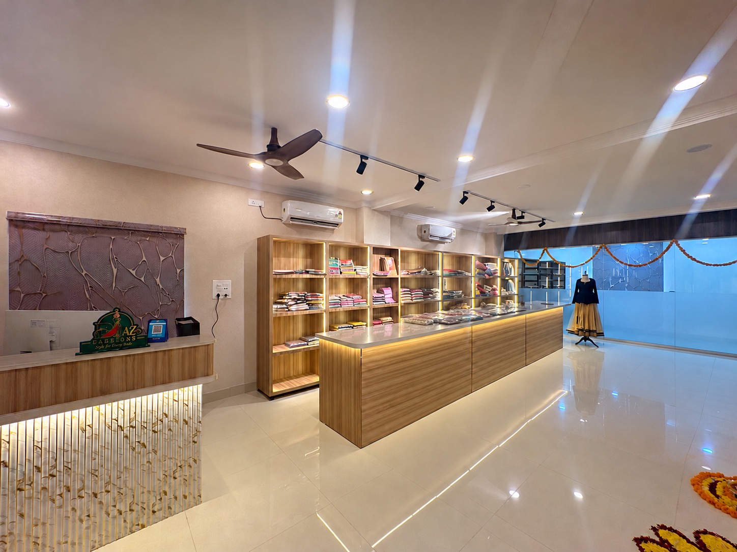 A wide view of the Ejaz Fashion boutique and its illuminated fabric counter