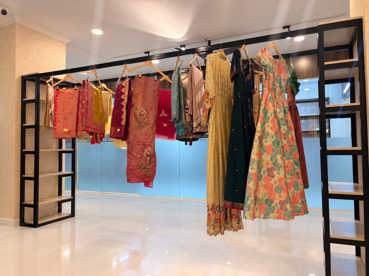 Colourful dresses and embroidered outfits on the boutique garment rail